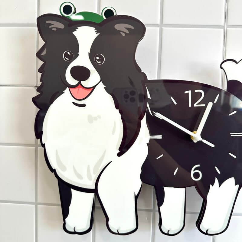Close-up of Border Collie dog clock face wearing a green frog hat