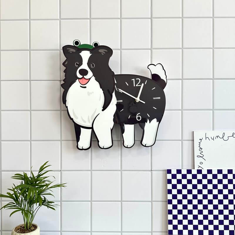 Border Collie dog clock hanging on white tiled wall above a potted green plant