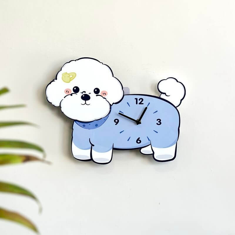Bichon Frise Saturn hairpin wall clock mounted on clean white wall with green plant decor