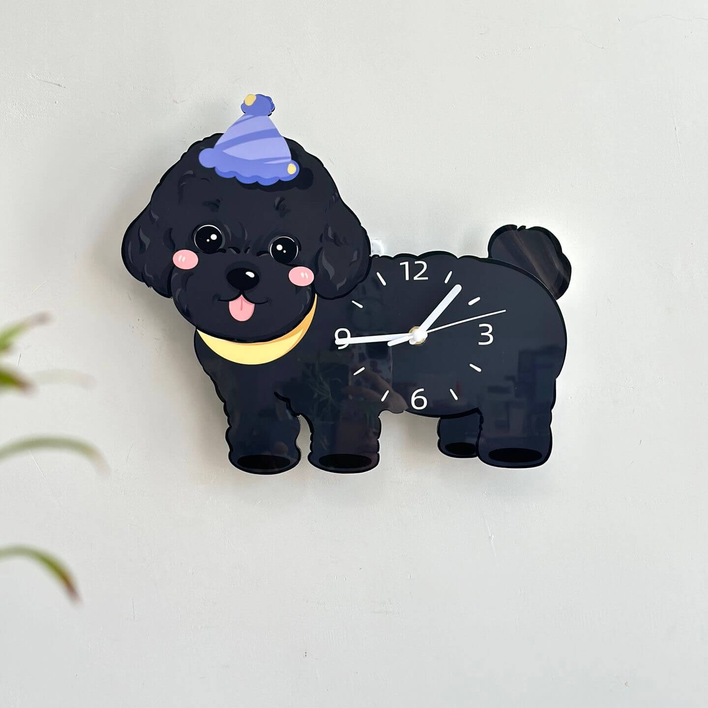 Black poodle dog clock on cream wall with green plant - modern pet home decor