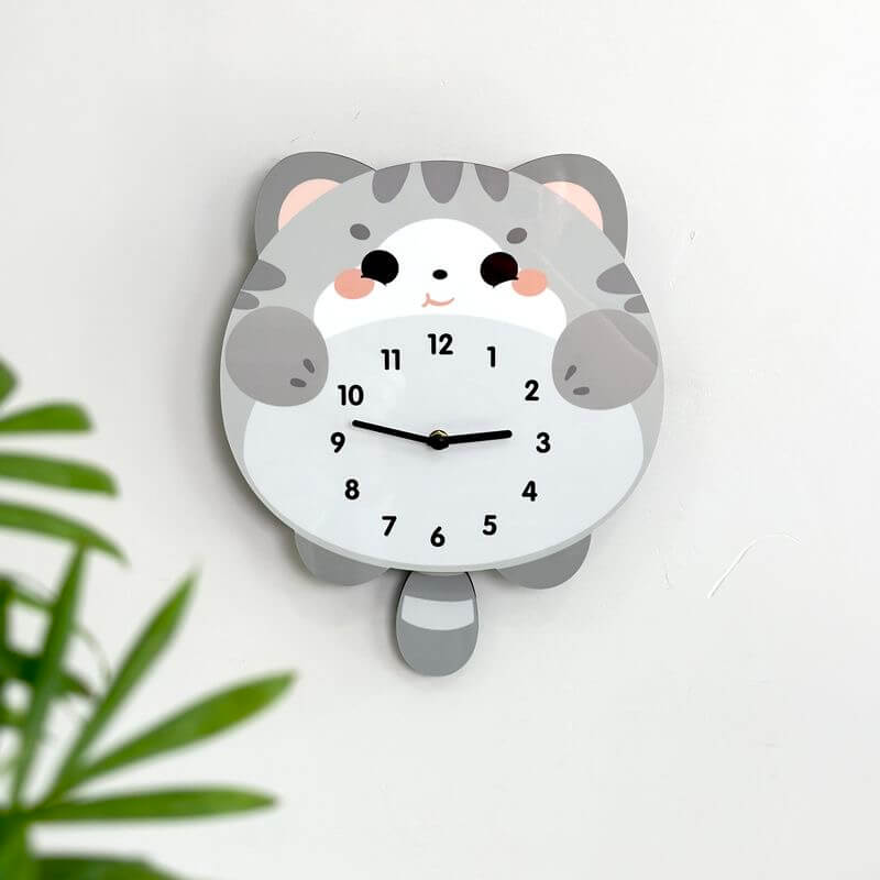 British Shorthair blue cat clock close-up showing adorable face and pink blush