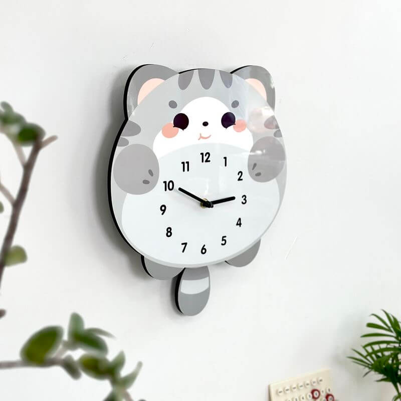 British Shorthair blue cat wall clock in room setting with plant and decorative items