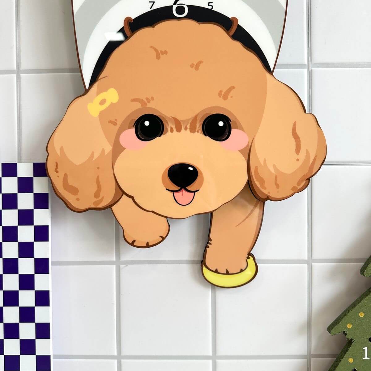 Brown Poodle lying clock close-up showing adorable face and yellow collar