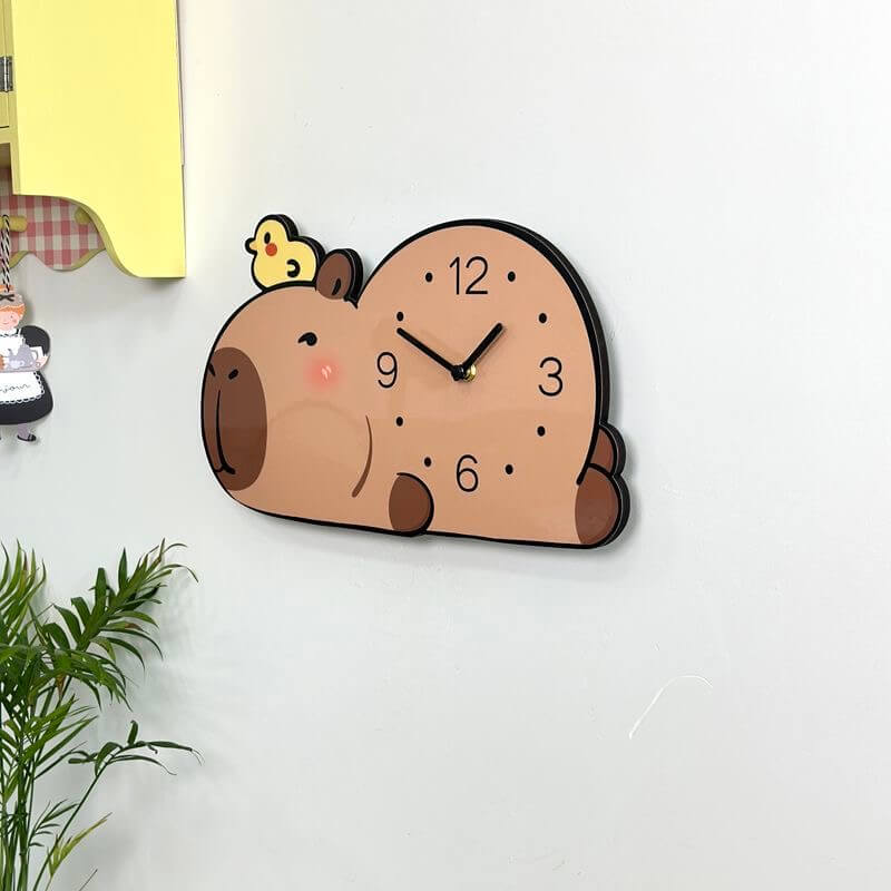 Capybara sleepy pet clock on cream wall with yellow cabinet and hanging kitchen figurine