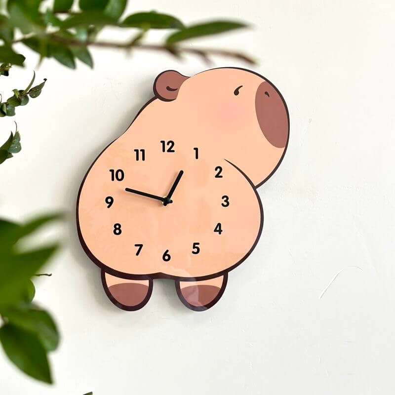 Capybara lying wall clock angled view showing cute face and body