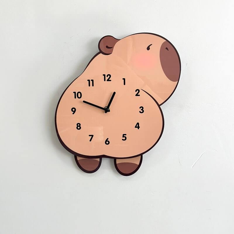 Capybara lying clock on white wall with green plant and home decor items