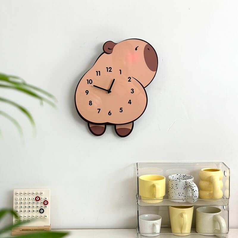 Capybara lying wall clock in room setting with plant and decorative items