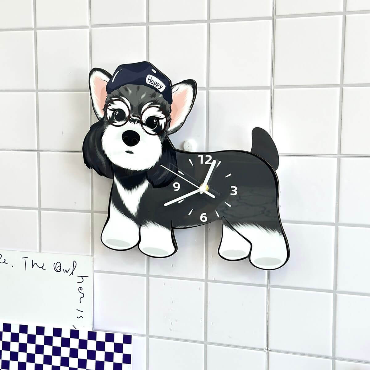 Schnauzer wall clock hanging on white tiled wall with checkered tile decor