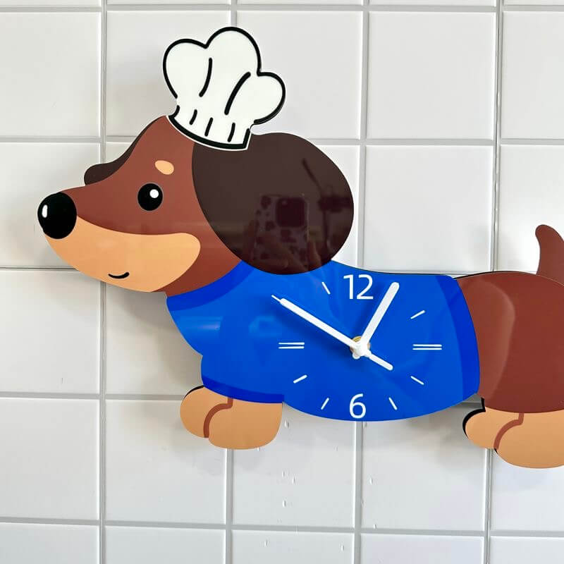 Close-up of dachshund chef hat clock on a white tile wall, showing clock face and hat detail