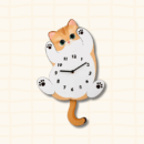 Cute orange tabby cat-shaped wall clock lying on back with paws up, green eyes and pink nose, cartoon acrylic design