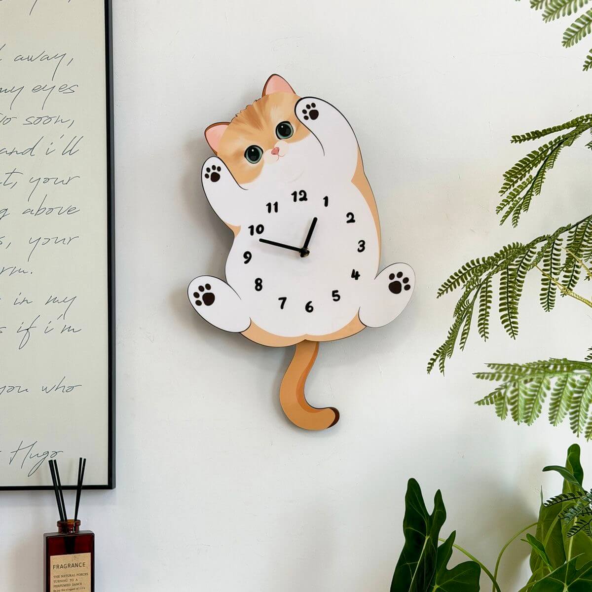 Orange tabby cat wall clock in room setting with plant and home decor