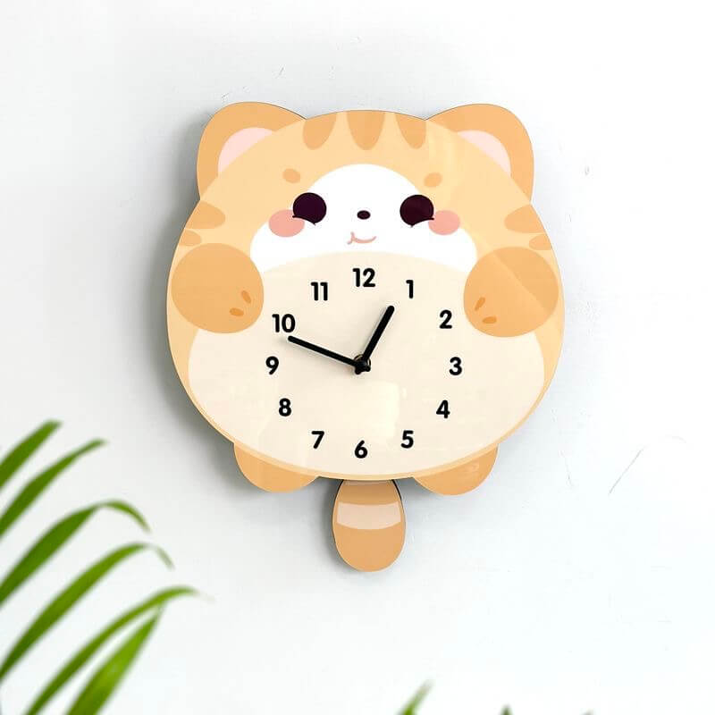 Orange tabby lying cat wall clock angled view showing cute round face and chubby body