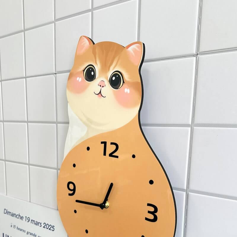 Orange tabby sitting cat wall clock in room setting with plant and decorative items