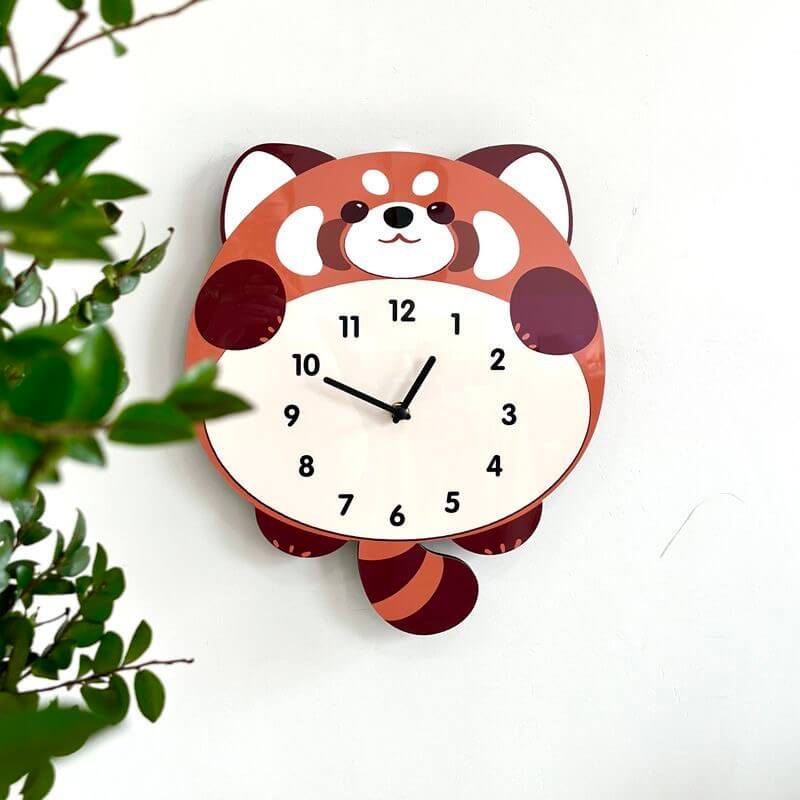 Red panda clock on cream wall with festive decor and Christmas tree
