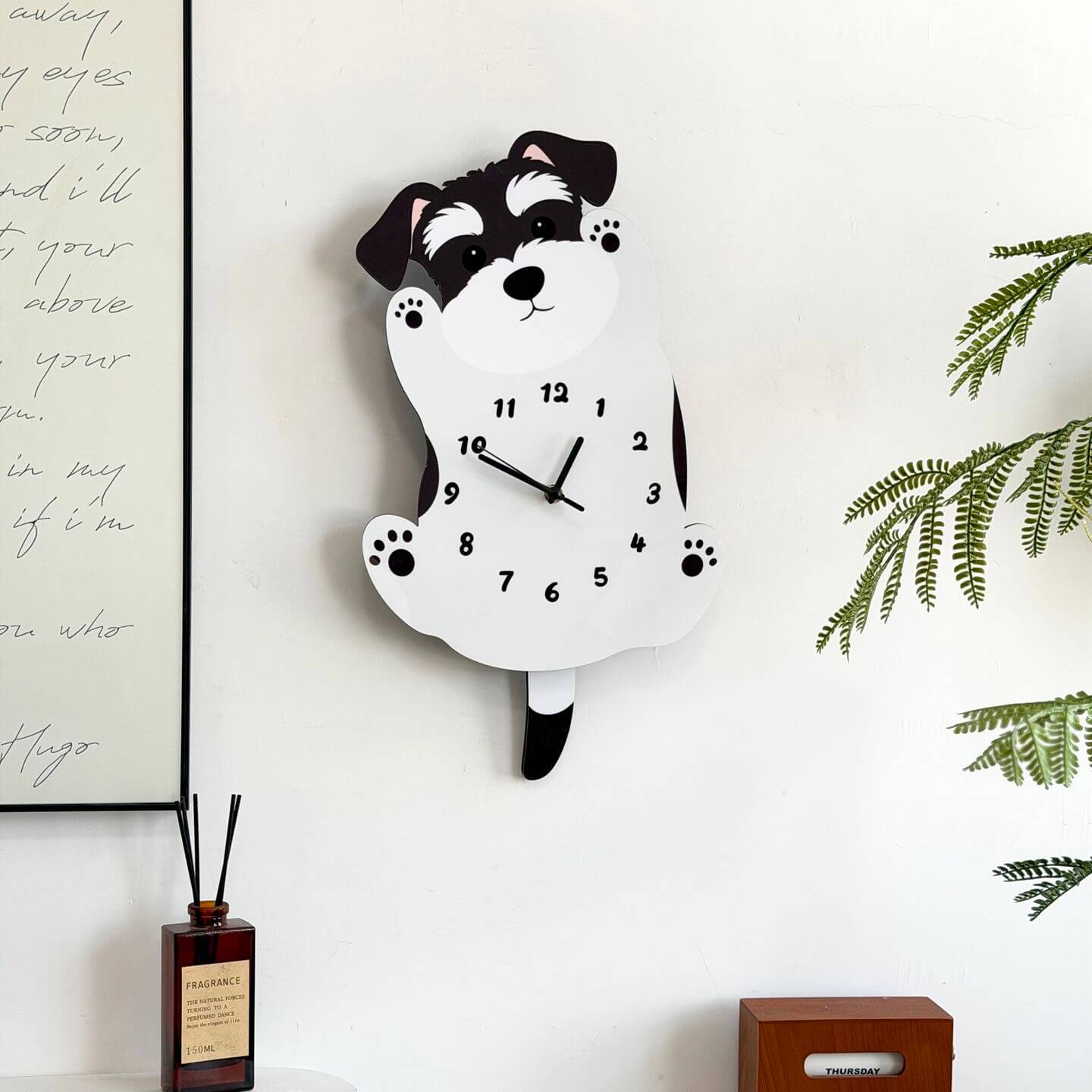 Schnauzer standing clock on white wall with green plant and home decor items